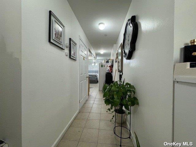 94-68 45th Ave, Elmhurst, NY 11373 - hallway with light tile patterned floors and baseboards