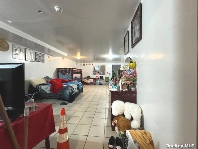 94-68 45th Ave, Elmhurst, NY 11373 - bedroom featuring light tile patterned floors