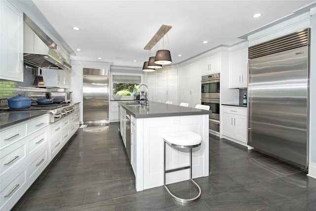 93 Haights Cross Rd, Chappaqua, NY 10514 - kitchen featuring stainless steel appliances, dark countertops, a sink, tasteful backsplash, and recessed lighting