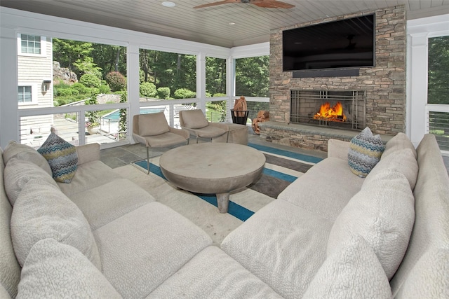 93 Haights Cross Rd, Chappaqua, NY 10514 - living area with a stone fireplace, ceiling fan, healthy amount of natural light, and wooden ceiling
