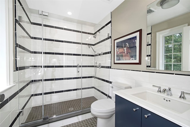 93 Haights Cross Rd, Chappaqua, NY 10514 - bathroom featuring vanity, toilet, a stall shower, tile walls, and tile patterned flooring