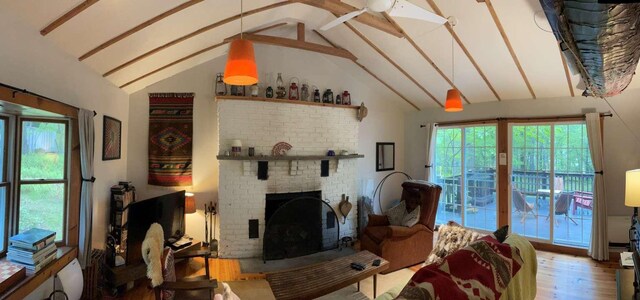 3 Perry Rd, Barryville, NY 12719 - living room with wood finished floors, a fireplace, beamed ceiling, and high vaulted ceiling