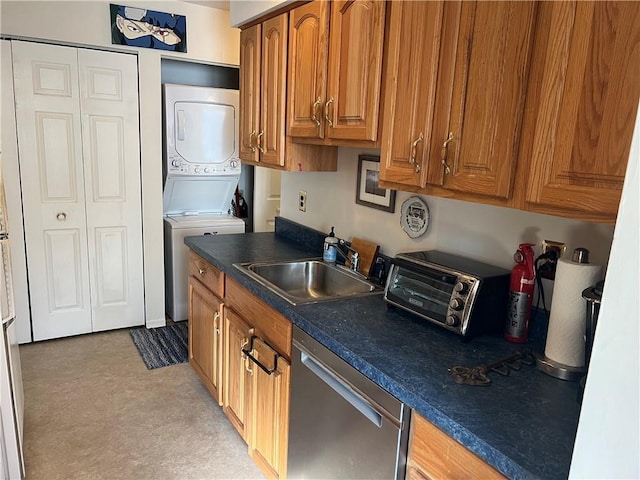 129 Main St Unit C8, Cornwall, NY 12518 - kitchen featuring dishwasher, stacked washer / dryer, a sink, brown cabinets, and dark countertops