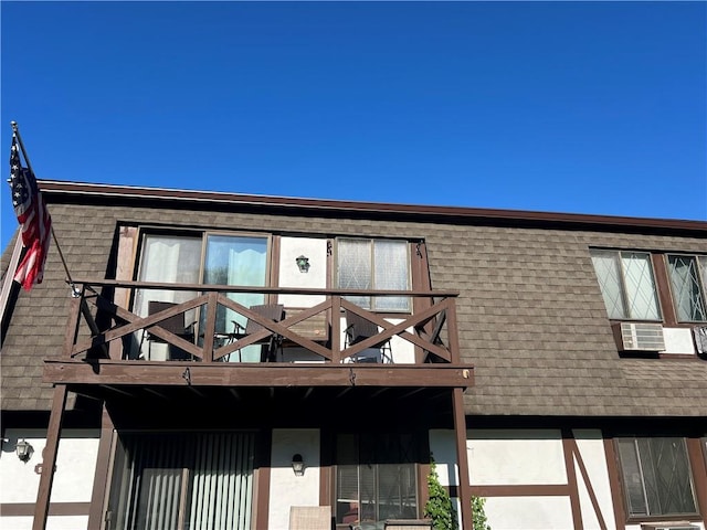 129 Main St Unit C8, Cornwall, NY 12518 - view of front facade featuring a balcony, roof with shingles, and stucco siding