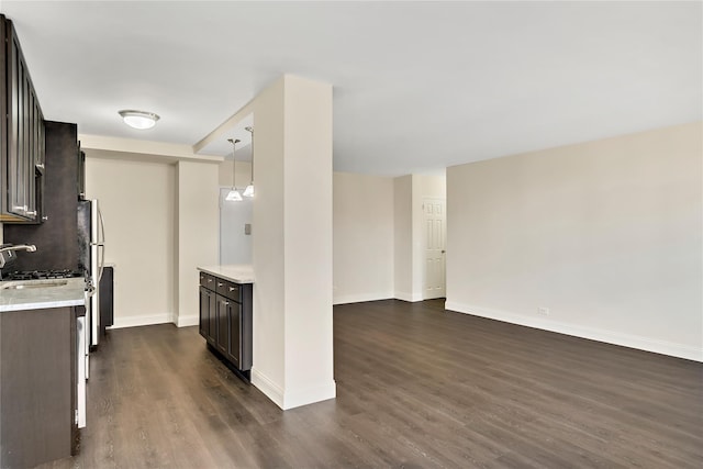 825 Morrison Ave Unit 5H, Bronx, NY 10473 - kitchen with dark wood-style floors, a sink, baseboards, hanging light fixtures, and open floor plan
