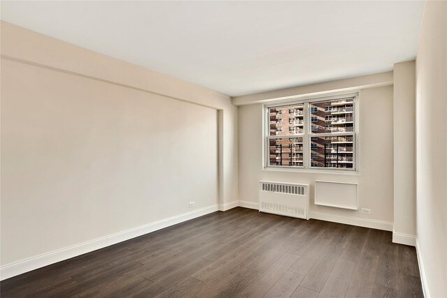 825 Morrison Ave Unit 5H, Bronx, NY 10473 - empty room with radiator heating unit, dark wood-style flooring, and baseboards