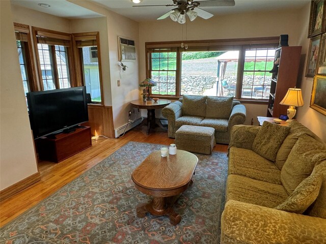 459 Illington Rd, Ossining, NY 10562 - living area featuring a ceiling fan, baseboard heating, wood finished floors, and a wall unit AC