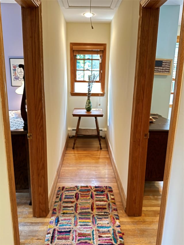 459 Illington Rd, Ossining, NY 10562 - hall featuring light wood finished floors, attic access, a baseboard heating unit, and baseboards