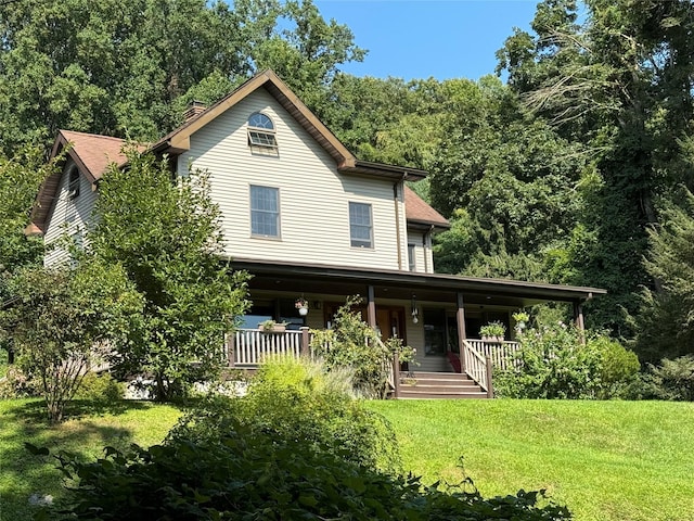 459 Illington Rd, Ossining, NY 10562 - view of front of house featuring covered porch, a front lawn, and a chimney