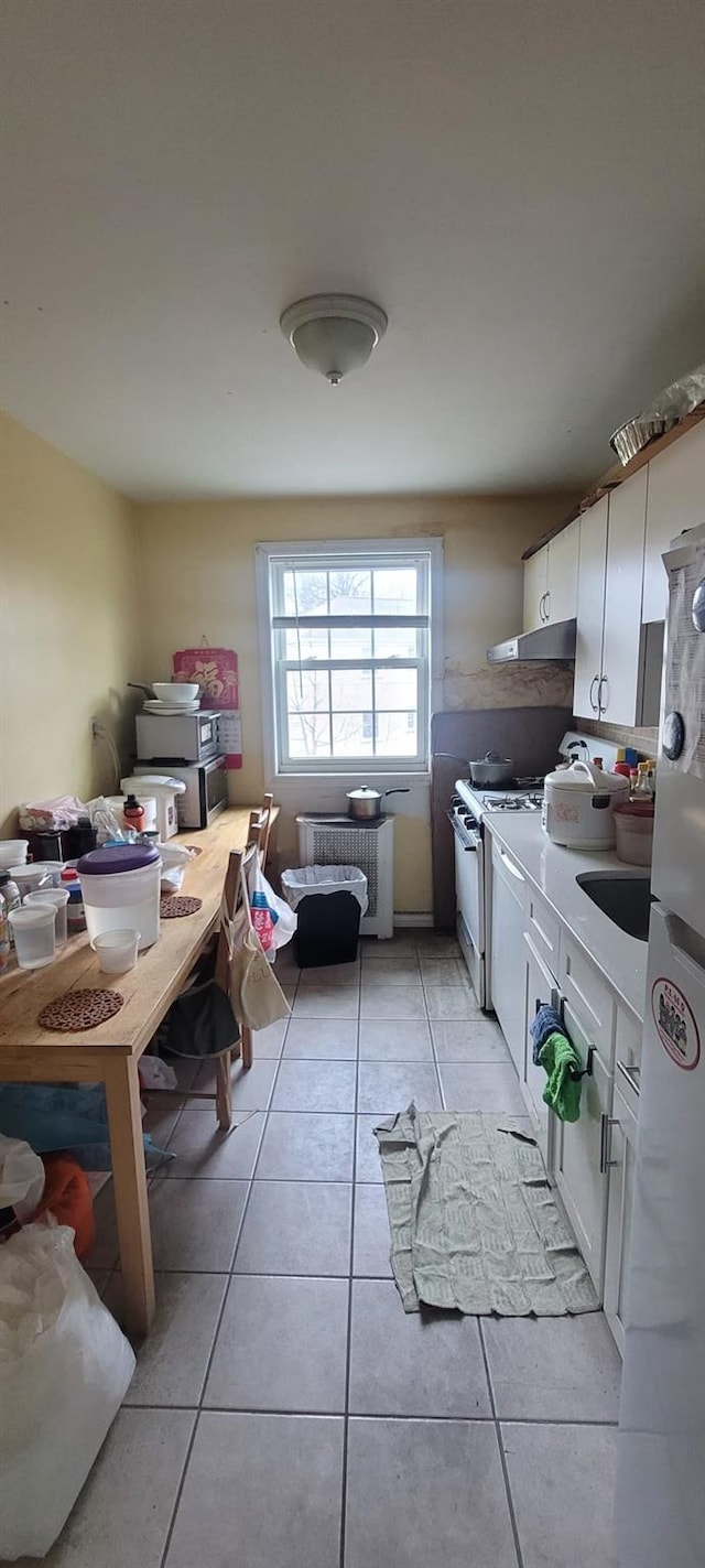 67-78 223rd Pl Unit B, Oakland Gardens, NY 11364 - kitchen featuring radiator, range hood, gas range gas stove, light tile patterned floors, and refrigerator