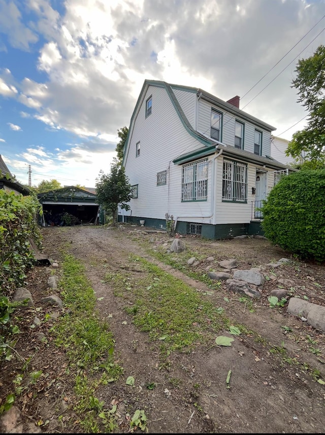 55-08 Haspel St, Elmhurst, NY 11373 - view of property exterior with a chimney