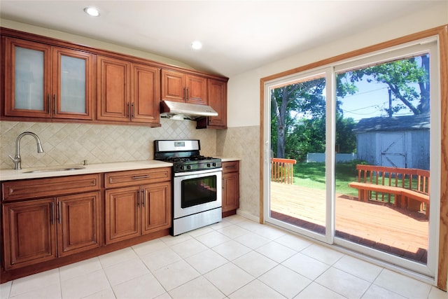 21 Rita Cres, Commack, NY 11725 - kitchen with gas range, light countertops, a sink, lofted ceiling, and plenty of natural light