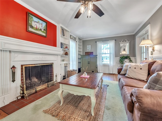 20 Tusten Ave, Goshen, NY 10924 - living area with ceiling fan, built in shelves, a fireplace with flush hearth, ornamental molding, and a wainscoted wall