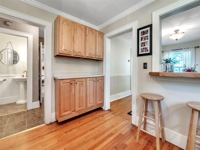 20 Tusten Ave, Goshen, NY 10924 - kitchen with light wood-type flooring, baseboards, crown molding, and light countertops
