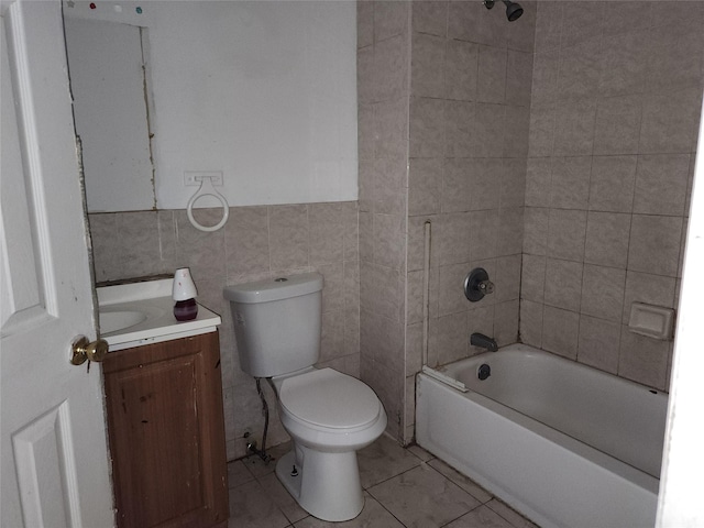 36 S 23rd St, Wyandanch, NY 11798 - bathroom featuring vanity, toilet, tub / shower combination, tile walls, and tile patterned flooring