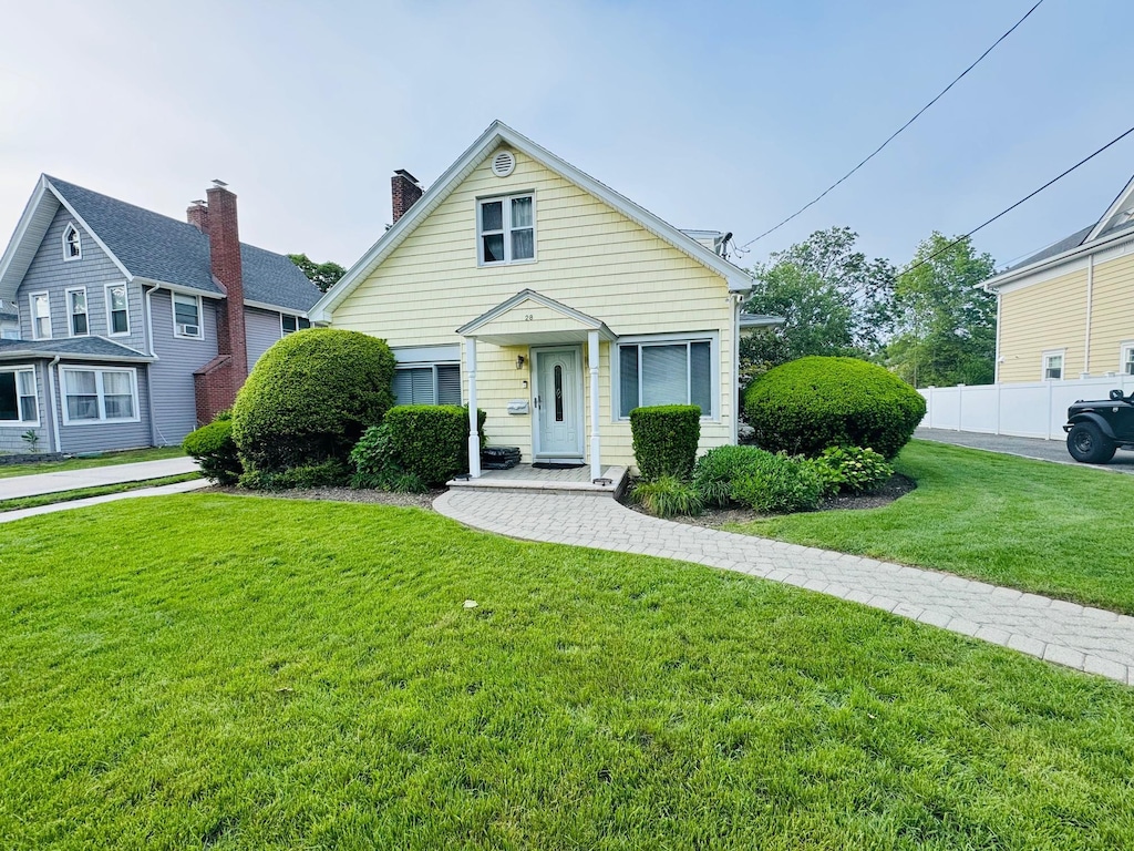 28 Brower Ave, Woodmere, NY 11598 - view of front of house featuring a chimney