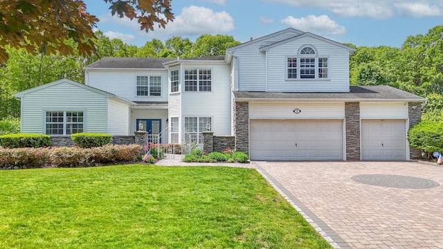 8 Wisteria Ln, Lake Grove, NY 11755 - view of front of property featuring stone siding, decorative driveway, and a front lawn