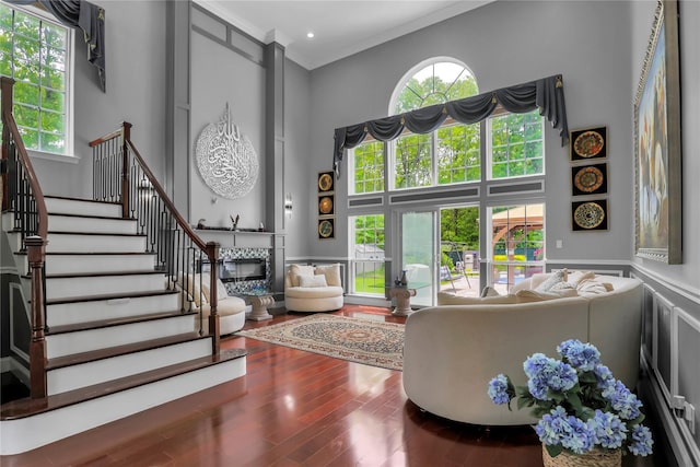 8 Wisteria Ln, Lake Grove, NY 11755 - foyer entrance with a towering ceiling, a glass covered fireplace, wood finished floors, stairway, and crown molding