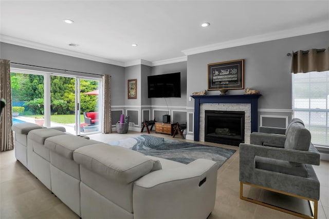 8 Wisteria Ln, Lake Grove, NY 11755 - living room with crown molding, a stone fireplace, recessed lighting, wainscoting, and a decorative wall
