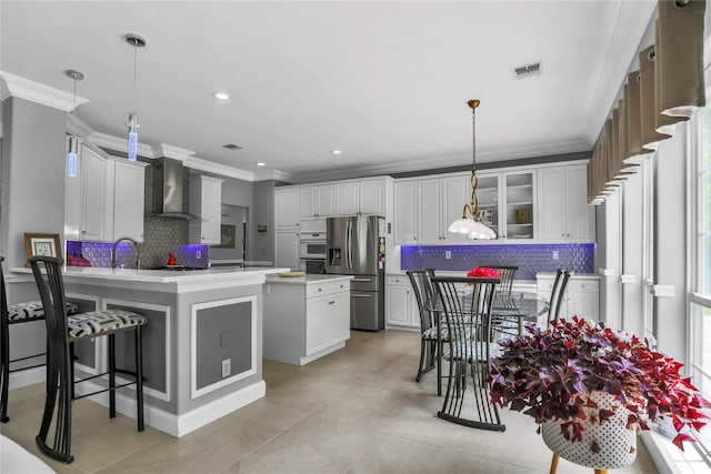 8 Wisteria Ln, Lake Grove, NY 11755 - kitchen with wall chimney range hood, stainless steel fridge with ice dispenser, crown molding, a peninsula, and decorative backsplash