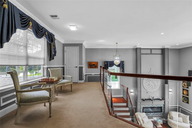 8 Wisteria Ln, Lake Grove, NY 11755 - living area with a glass covered fireplace, healthy amount of natural light, carpet flooring, a decorative wall, and crown molding