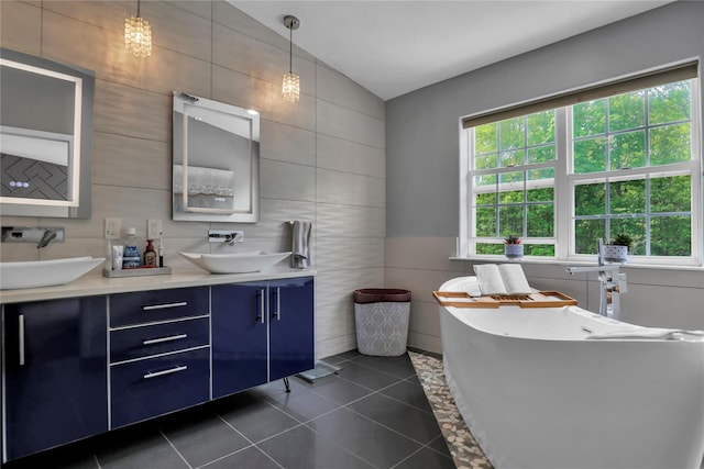 8 Wisteria Ln, Lake Grove, NY 11755 - full bathroom featuring tile walls, a freestanding bath, double vanity, and tile patterned floors