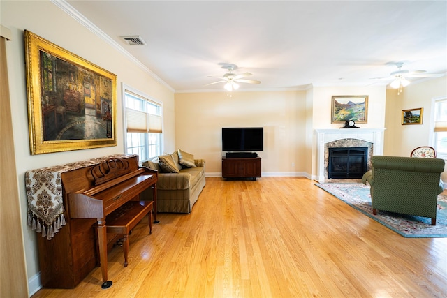 14 Gordon Ave, Plainview, NY 11803 - living room featuring ceiling fan, light wood-style floors, a premium fireplace, and crown molding