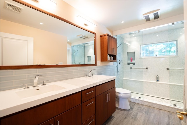 14 Gordon Ave, Plainview, NY 11803 - bathroom with toilet, a tile shower, double vanity, decorative backsplash, and wood finished floors