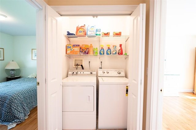 14 Gordon Ave, Plainview, NY 11803 - washroom featuring separate washer and dryer, light wood-style flooring, and bar area