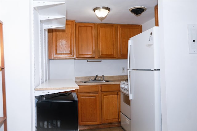 100 Randall Ave Unit 4J, Freeport, NY 11520 - kitchen with white appliances, a sink, light countertops, and brown cabinetry