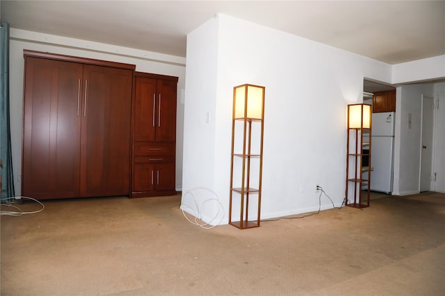 100 Randall Ave Unit 4J, Freeport, NY 11520 - unfurnished bedroom with freestanding refrigerator and light colored carpet