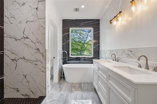 615 Union Rd, Spring Valley, NY 10977 - full bath with tile walls, a soaking tub, double vanity, marble tiled floors, and a marble finish shower