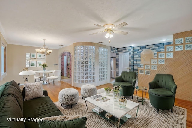 8 Adolphi Pl, Ronkonkoma, NY 11779 - living area featuring a chandelier, light wood finished floors, ceiling fan, and ornamental molding