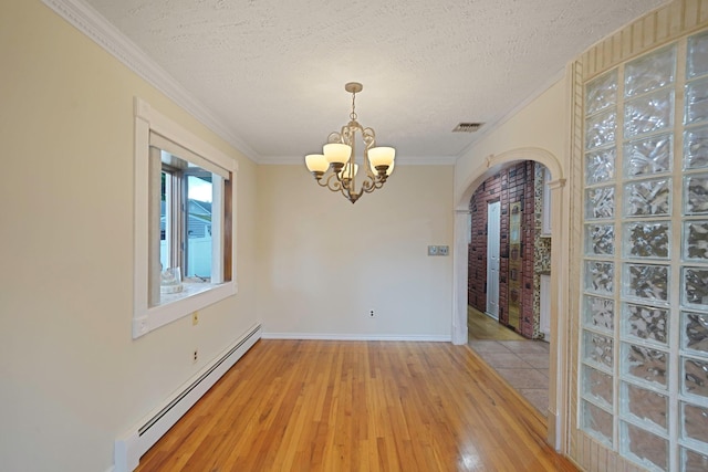 8 Adolphi Pl, Ronkonkoma, NY 11779 - empty room with baseboard heating, light wood-style flooring, a chandelier, a textured ceiling, and ornamental molding