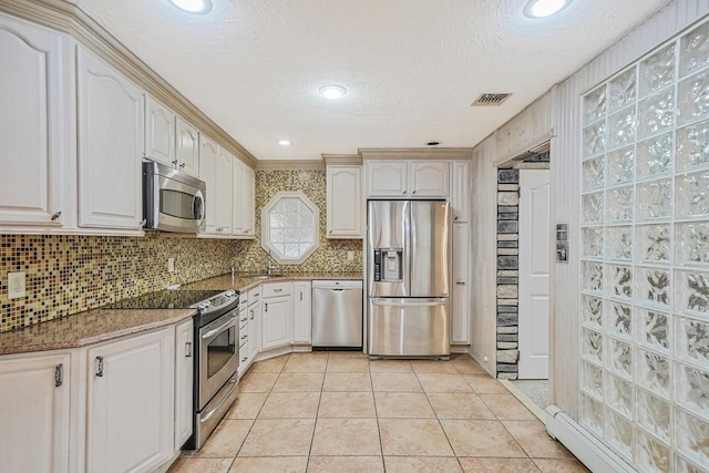 8 Adolphi Pl, Ronkonkoma, NY 11779 - kitchen with appliances with stainless steel finishes, a baseboard heating unit, tasteful backsplash, a textured ceiling, and stone countertops