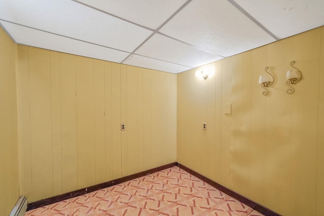 8 Adolphi Pl, Ronkonkoma, NY 11779 - unfurnished room featuring a baseboard heating unit and a drop ceiling