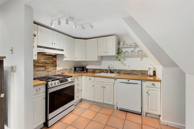 6 Davis Ave Unit A42, Rye, NY 10580 - kitchen with dishwasher, gas stove, a sink, under cabinet range hood, and open shelves