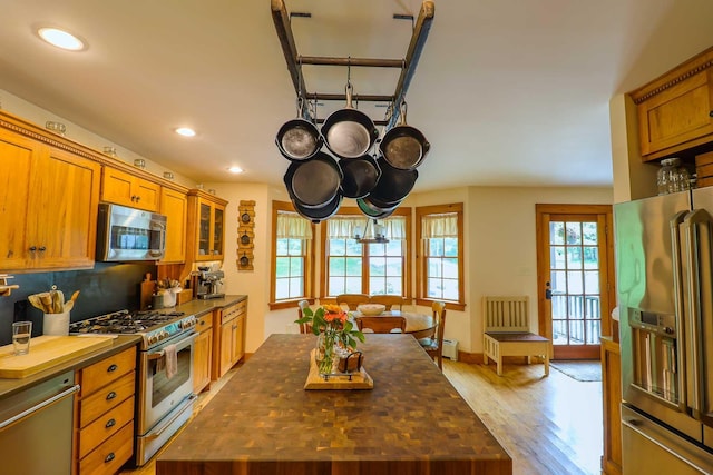 470 Winding Hill Rd, Montgomery, NY 12549 - kitchen featuring appliances with stainless steel finishes, brown cabinetry, light wood finished floors, recessed lighting, and a center island