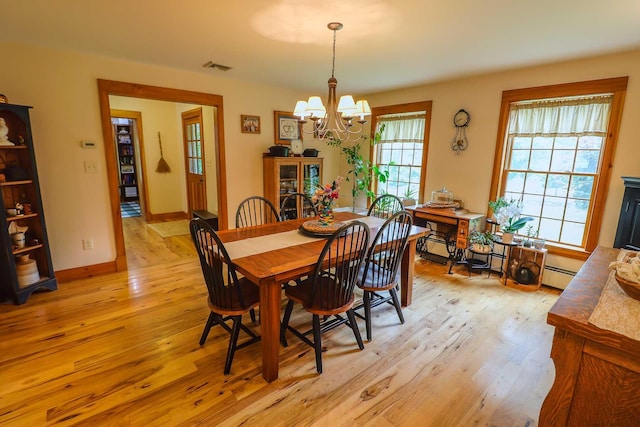 470 Winding Hill Rd, Montgomery, NY 12549 - dining room featuring a chandelier, light wood-style floors, a baseboard radiator, and baseboards