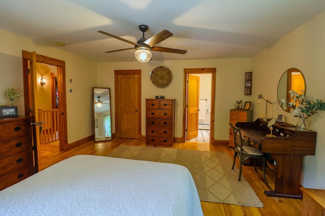 470 Winding Hill Rd, Montgomery, NY 12549 - bedroom featuring a baseboard radiator, light wood-style flooring, baseboards, ensuite bath, and ceiling fan
