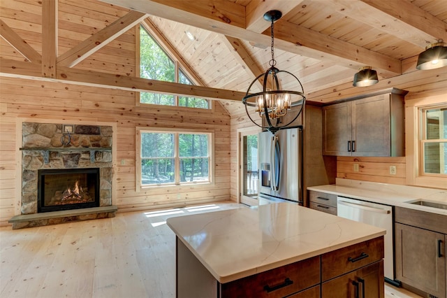 57 Zane Grey Way, Barryville, NY 12719 - kitchen with appliances with stainless steel finishes, wood ceiling with exposed beams, wood walls, light wood-type flooring, and a chandelier