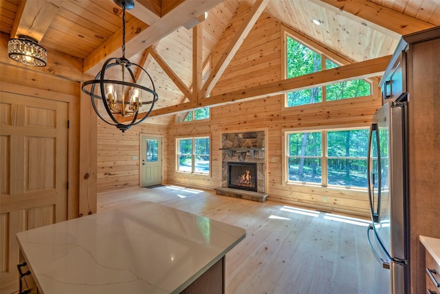 57 Zane Grey Way, Barryville, NY 12719 - unfurnished living room with a chandelier, wood ceiling with exposed beams, wood walls, high vaulted ceiling, and light wood-style flooring