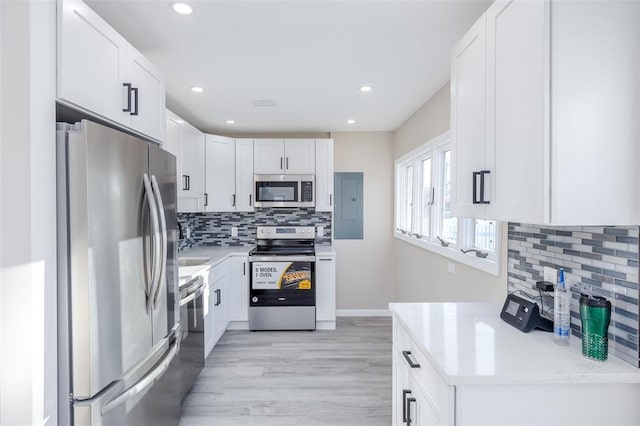 24 Commander Ave, Hempstead, NY 11550 - kitchen with stainless steel appliances, backsplash, light wood finished floors, light countertops, and recessed lighting