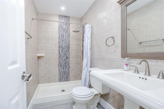 24 Commander Ave, Hempstead, NY 11550 - bathroom featuring toilet, a stall shower, tile walls, a sink, and decorative backsplash