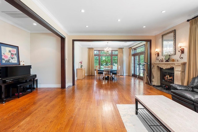 23 Tanners Rd, Great Neck, NY 11020 - living room with crown molding, a chandelier, light wood-type flooring, a high end fireplace, and baseboards