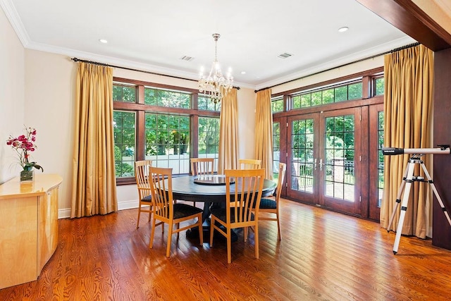 23 Tanners Rd, Great Neck, NY 11020 - dining room with ornamental molding, french doors, a chandelier, wood finished floors, and recessed lighting