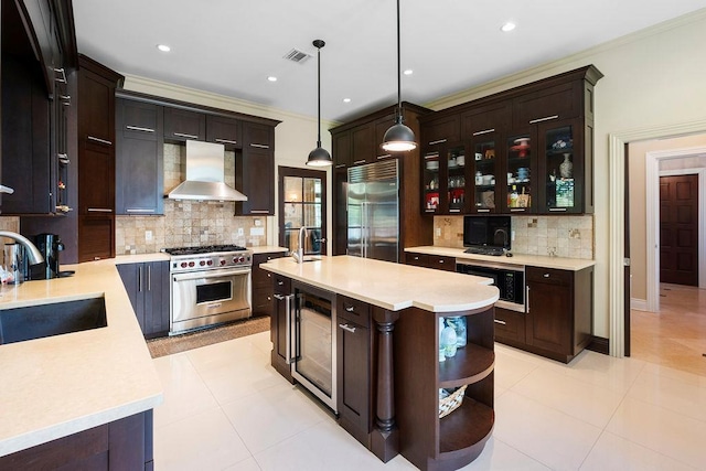 23 Tanners Rd, Great Neck, NY 11020 - kitchen with high end appliances, wall chimney range hood, a sink, wine cooler, and tasteful backsplash