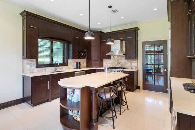 23 Tanners Rd, Great Neck, NY 11020 - kitchen featuring a sink, wall chimney range hood, light countertops, healthy amount of natural light, and crown molding