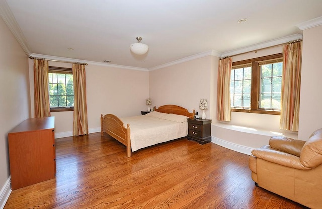 23 Tanners Rd, Great Neck, NY 11020 - bedroom with baseboards, wood finished floors, and ornamental molding