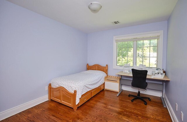 23 Tanners Rd, Great Neck, NY 11020 - bedroom with wood finished floors, a desk, and baseboards